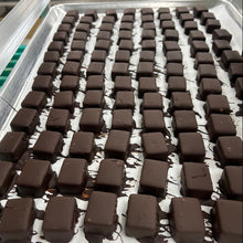 Load image into Gallery viewer, Tray of chocolate bars in a factory setting
